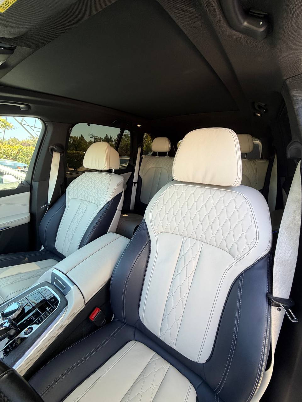 Ivory and dark leather front seats in a BMW X5